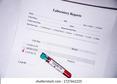 Medical Test Tube With A Blood Test For Coronavirus COVID-19 With Laboratory Report 