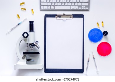 Medical Tests. Work Table Of Doctor Witn Microscope, Petri Dish, Syringe On White Background Top View Mockup