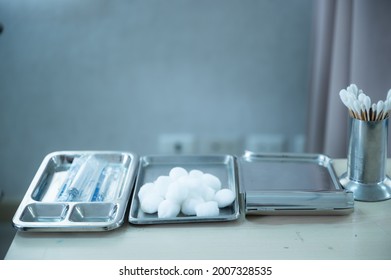 Medical Tools, Medical Kit On The Stanless Steel Table, Wheelchair, Cotton Bud, Hospital Bed, Syringe, Medication Tray, Pill Counting Tray. 