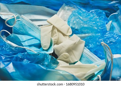 Medical trash. Coronavirus protection equipment in medical waste bin. Used face masks and sterile gloves. Doctor uniform for patient treatment in hospital. Prevention the spread of COVID-19. - Shutterstock ID 1680951010