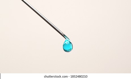 Medical Vaccine Dripping From The Syringe Needle. Concept Of Lab Developing Research Of Vaccine Against Coronavirus, COVID-19. Pre-clinical Evaluation And Clinical Phase Trials Development Test