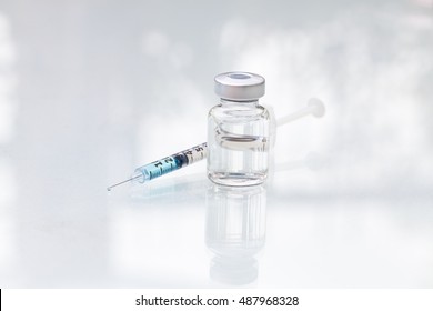 Medical vials for injection with a syringe isolated on white background.