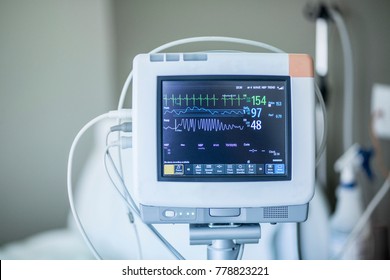 Medical Vital Signs Monitor Instrument In A Hospital. This Health Care Device Displays And Monitors Heart Rate And Oxygen Levels In Hospital Patients