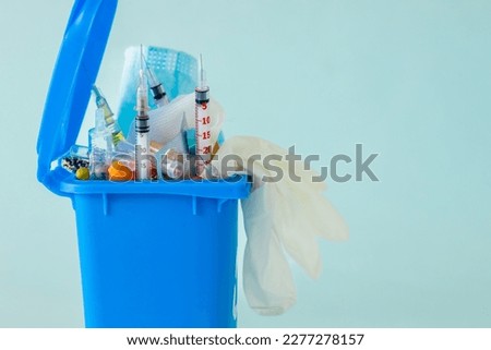 Medical waste concept, Open garbage full of pills, syringes, bandages, masks, protective gloves. Utilization and storage of hospital waste, copy space