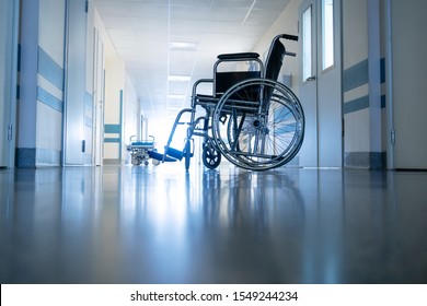 Medical wheelchair in the hospital corridor. Backlit shot. - Powered by Shutterstock