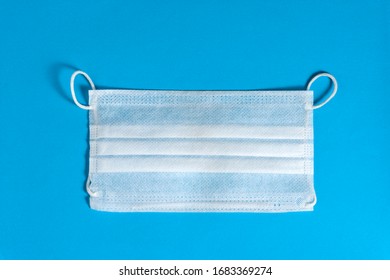 Medical White Face Mask On A Blue Background.