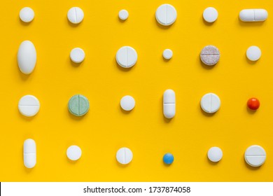 Medical white pills on a yellow background. Pharmaceutical concept - Shutterstock ID 1737874058