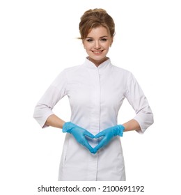 Medical woman in white coat and blue gloves shows heart gesture in the lower abdomen isolated on white background.