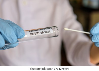 Medical worker holding swab sample collection kit, test tube for performing patient nasal swabbing. Hands in gloves holding testing equipment for Coronavirus COVID-19 diagnostic. - Shutterstock ID 1734275999
