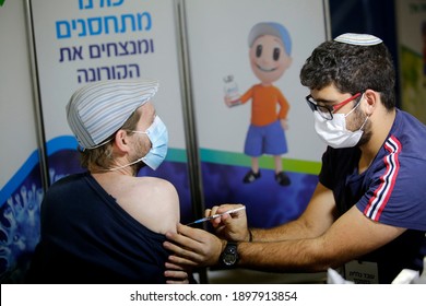 A medical worker inoculates a recipient with a COVID-19 vaccine in Jerusalem, Jan. 10, 2021.