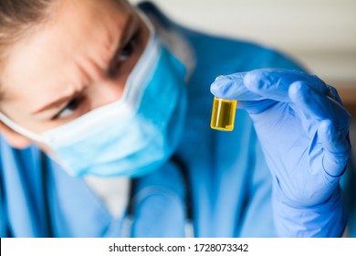 Medical Worker Inspecting Ampoule Vial Bottle Filled With Yellow Liquid,COVID-19 Potential Vaccine Cure Develop,convalescent Patient Platelet Rich Blood Plasma Transfusion,Coronavirus Therapy Concept