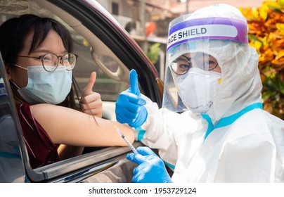 Medical Worker And Patient Showing Thumbs Up After Injecting Covid-19 Vaccine In COVID-19 Drive-thru Detection Site.