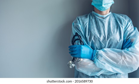 Medical worker portrait without face dressed in disposable medical gown and protective mask