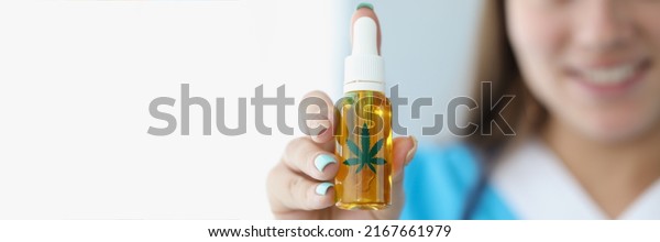 Medical worker present cannabis oil in plastic\
bottle for alternative\
treatment