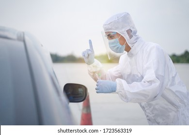 Medical Worker In Protective Suit Screening Driver To Sampling Secretion To Check For Covid-19. Drive Thru Test Coronavirus Fast Track. Concept Prevention Coronavirus Outbreak.