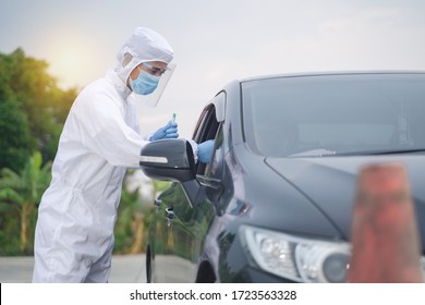 Medical Worker In Protective Suit Screening Driver To Sampling Secretion To Check For Covid-19. Drive Thru Test Coronavirus Fast Track. Concept Prevention Coronavirus Outbreak.