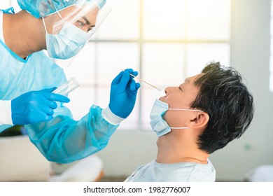 Medical worker taking  swab for corona virus sample from potentially infected  man - Shutterstock ID 1982776007