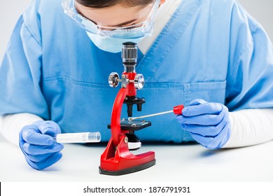 Medical Worker UK Lab Technician Microscope Examining Coronavirus Patient Swab Test Tube Sample Specimen,COVID-19 Rt-PCR (real Time Reverse Transcription Polymerase Chain Reaction) Testing Procedure