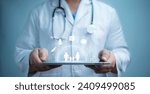 A medical worker using  tablet with virtual health care icons, medical technology background, health insurance business.Health Insurance, telemedicine, virtual hospital, family medicine concept. 