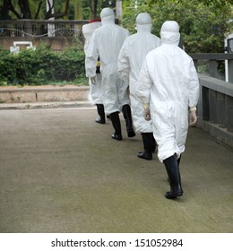 Medical Worker Wearing A Gas Mask And A Lab Coat.