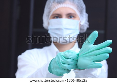 Medical worker wearing gloves before surgery