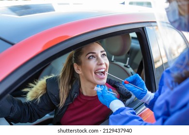 Medical Worker Wearing Personal PPE Surgical Gloves And Protective Clothing, Holding Nasal Swab, Performing Drive-thru COVID-19 Testing, Point Of Care On Site Location For PCR Detection Of Coronavirus