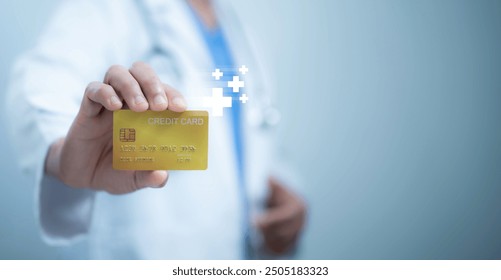 A medical worker in a white coat holding a credit card, representing healthcare and financial transactions, health insurance payments, healthcare financing, and the cost of medical services concepts - Powered by Shutterstock