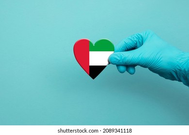 Medical Workers Hand Wearing Surgical Glove Holding UAE Flag Heart