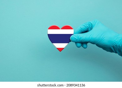 Medical Workers Hand Wearing Surgical Glove Holding Thailand Flag Heart