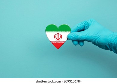 Medical Workers Hand Wearing Surgical Glove Holding Iran Flag Heart