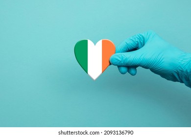 Medical Workers Hand Wearing Surgical Glove Holding Ireland Flag Heart