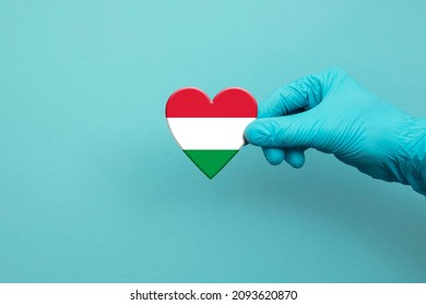 Medical Workers Hand Wearing Surgical Glove Holding Hungary Flag Heart