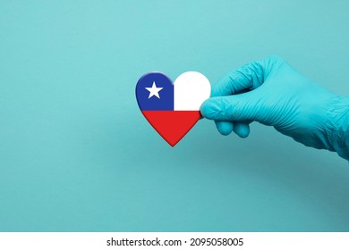 Medical Workers Hand Wearing Surgical Glove Holding Chile Flag Heart