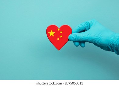 Medical Workers Hand Wearing Surgical Glove Holding China Flag Heart