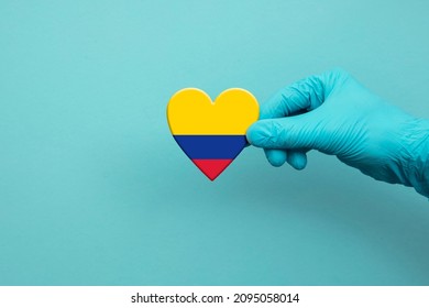 Medical Workers Hand Wearing Surgical Glove Holding Colombia Flag Heart