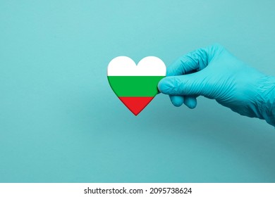 Medical Workers Hand Wearing Surgical Glove Holding Bulgaria Flag Heart