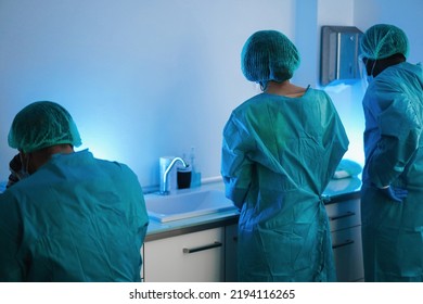 Medical Workers In Hazmat Suit Working With Microscope Inside Modern Laboratory Hospital - Focus On Nurse Head