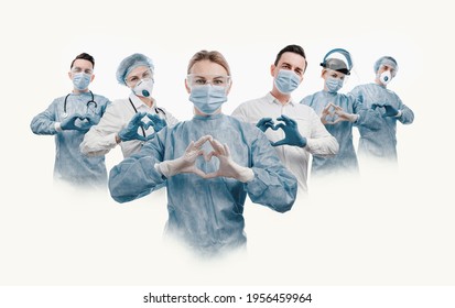 Medical Workers Heroes. A Nurse In The Foreground In A Mask And Uniform Holds Her Hands In The Shape Of A Heart. Go To A Lot Of Medical Professionals.