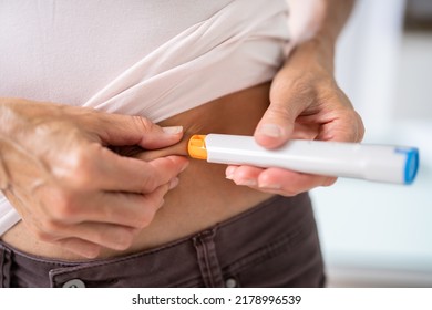 Medicament Self Injection In Belly Using Syringe With Drug