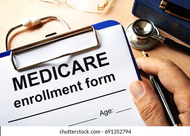 Medicare Enrollment Form In A Hand.