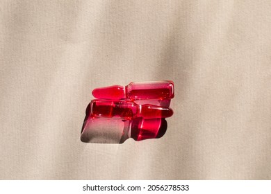 Medication Capsules With Pink Liquid On A Gray Background. Liquid For Injections Vitamin B. 