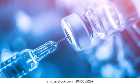 Medication drug needle syringe drug,medical concept flu shot vaccine vial dose hypodermic injection treatment disease care hospital prevention immunization illness disease  baby child.blue background - Powered by Shutterstock