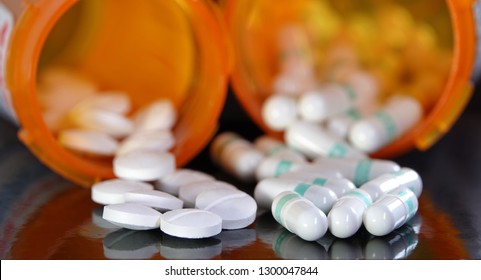 Medication Overuse Or Adverse Drug Interaction Concept - Two Types Of Prescription Drugs Spilling From Containers                              