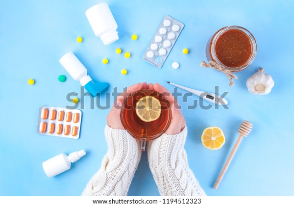 Medications, pills,\
thermometer, traditional medicine for treating colds, flu, heat on\
a blue background. Maintenance of immunity. Seasonal diseases. Top\
view. Medicine flat\
lay