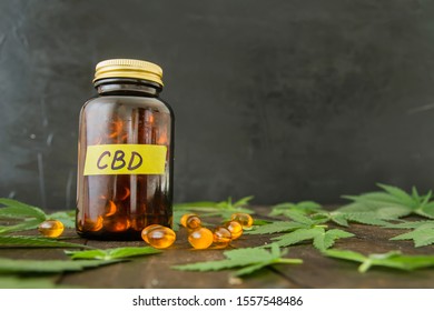 Medicinal CBD Oil Capsules And Hemp Leaves 