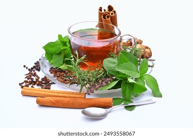 Medicinal herbal tea, with ingredients, immunity booster drink, Tulsi, holy basil leaves, rosemary, cinnamon sticks, cloves, mint, peppercorns, ginger - Powered by Shutterstock