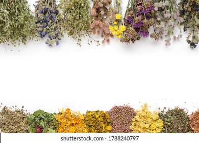 Medicinal plants bunches and piles of medicinal herbs on white background. Top view, flat lay. Alternative medicine. Copy space for text.