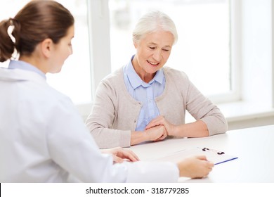 medicine, age, health care and people concept - doctor with clipboard and senior woman meeting at hospital - Powered by Shutterstock