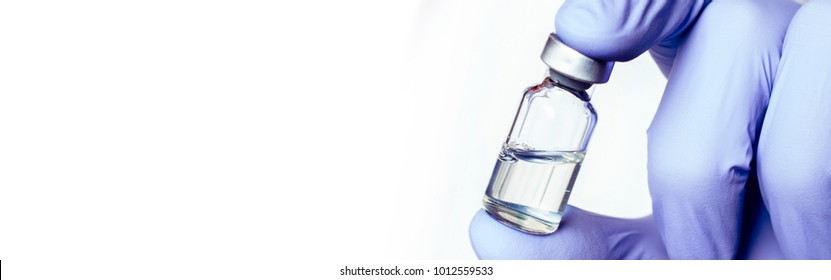 Medicine bottle for injection in hand, palm of a doctor. Medical glass vial for vaccination. Science equipment, liquid drug or vaccine from treatment, flu in laboratory, hospital or pharmacy. 