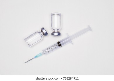 Medicine bottle for injection. Medical glass vials and syringe for vaccination. liquid drug or vaccine for treatment, flu in laboratory, hospital or pharmacy concept isolated on white background.